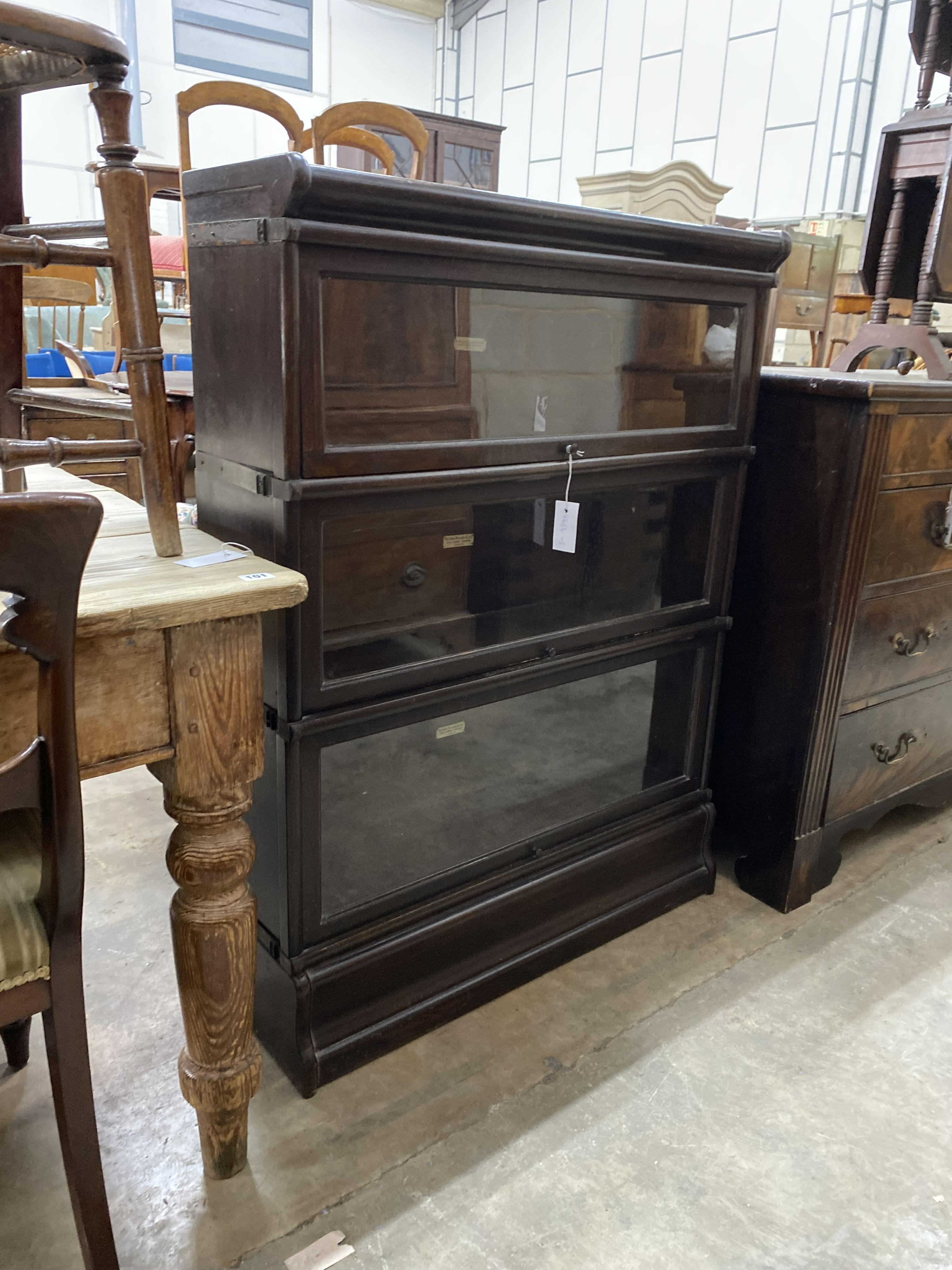 A Globe Wernicke three section glazed oak bookcase, length 86cm, depth 27cm, height 115cm